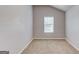 Bedroom with a single window has neutral walls and carpeting, and white base trim at 2030 Beyers Landing Dr, Buford, GA 30519