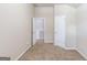Bedroom with a closet has neutral walls and carpeting, with white base trim, doors, and door hardware at 2030 Beyers Landing Dr, Buford, GA 30519