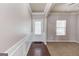 Home foyer area features wood flooring and view of living room with carpet at 2030 Beyers Landing Dr, Buford, GA 30519