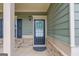 Front door with glass and black frame, front porch with traditional features at 2030 Beyers Landing Dr, Buford, GA 30519