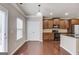 Bright kitchen with stainless appliances, wood floors, and pantry doors at 2030 Beyers Landing Dr, Buford, GA 30519