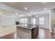 Open kitchen island, dark wood floors, and dining/living area in the background at 2030 Beyers Landing Dr, Buford, GA 30519