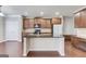 Open-concept kitchen boasts granite countertops, wooden cabinets, and modern appliances at 2030 Beyers Landing Dr, Buford, GA 30519