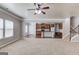 Spacious living room features neutral carpet, open floor plan to kitchen, and staircase at 2030 Beyers Landing Dr, Buford, GA 30519