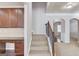 Welcoming foyer with staircase featuring carpeted steps, dark wood trim, and entry to the living space at 2030 Beyers Landing Dr, Buford, GA 30519