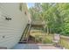 Backyard with spacious wooden deck and staircase leading to a second level deck surrounded by trees at 3781 Deercreek Dr, Powder Springs, GA 30127