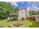 Spacious backyard with a deck, green lawn, garden beds and storage shed at 3781 Deercreek Dr, Powder Springs, GA 30127