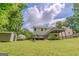 Well-manicured backyard features a deck, storage shed, and green lawn at 3781 Deercreek Dr, Powder Springs, GA 30127