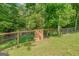 Backyard features wooden fence and lush green trees at 3781 Deercreek Dr, Powder Springs, GA 30127