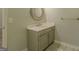 Neutral bathroom with updated vanity, round mirror, and gray flooring at 3781 Deercreek Dr, Powder Springs, GA 30127
