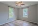 A bright bedroom featuring two windows and modern ceiling fan at 3781 Deercreek Dr, Powder Springs, GA 30127