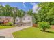 Attractive two-story home with a well-manicured lawn, two-car garage, and a peaceful, tree-lined setting at 3781 Deercreek Dr, Powder Springs, GA 30127