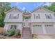 Classic two-story home with a two-car garage, complemented by vibrant flowerbeds and a welcoming entrance at 3781 Deercreek Dr, Powder Springs, GA 30127