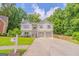 Charming two-story home with a two-car garage, landscaped front yard, and a welcoming front entrance at 3781 Deercreek Dr, Powder Springs, GA 30127
