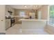Renovated kitchen with stainless steel appliances, white tile backsplash, granite countertop, and stylish chandelier at 3781 Deercreek Dr, Powder Springs, GA 30127
