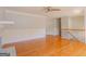 A light-filled living area with hardwood floors and light-grey painted walls leads to the staircase at 3781 Deercreek Dr, Powder Springs, GA 30127