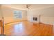 Spacious living room featuring hardwood floors, a ceiling fan, and a fireplace, offering a cozy atmosphere at 3781 Deercreek Dr, Powder Springs, GA 30127