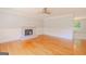 Spacious living room features a fireplace, hardwood floors, a ceiling fan, and elegant wainscoting at 3781 Deercreek Dr, Powder Springs, GA 30127