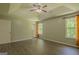 Spacious main bedroom with a tray ceiling, fan, and two windows allowing natural light at 3781 Deercreek Dr, Powder Springs, GA 30127