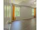 Bright main bedroom with tray ceiling, fan, wood-look flooring, and ample natural light at 3781 Deercreek Dr, Powder Springs, GA 30127