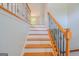 Elegant staircase featuring decorative wrought iron railings and wood treads, providing a stylish transition at 3781 Deercreek Dr, Powder Springs, GA 30127