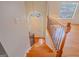 Staircase with wooden steps and ornate railing leading to a bright entryway with hardwood flooring at 3781 Deercreek Dr, Powder Springs, GA 30127