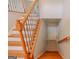 Elegant staircase with wooden banister and decorative iron spindles at 3781 Deercreek Dr, Powder Springs, GA 30127