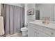 Well-lit bathroom featuring a neutral shower curtain and a white vanity with countertop at 4520 Odum Lake Trl, Cumming, GA 30040