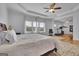 Large bedroom features a tray ceiling, an attached bonus space, and hardwood floors at 4520 Odum Lake Trl, Cumming, GA 30040