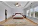 Bright bedroom features a tray ceiling, large windows, and hardwood floors at 4520 Odum Lake Trl, Cumming, GA 30040