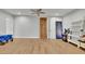 Spacious bonus room with wood-look floors, ceiling fan and arcade game, perfect for fun and relaxation at 4520 Odum Lake Trl, Cumming, GA 30040