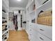Walk-in closet features custom shelves, drawers, and plenty of storage space at 4520 Odum Lake Trl, Cumming, GA 30040