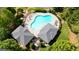 Aerial view of a community pool, surrounded by lounge chairs, lush greenery and covered pavillions at 4520 Odum Lake Trl, Cumming, GA 30040