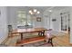 Bright dining room featuring hardwood floors, classic trim, bench seating, and charming french doors at 4520 Odum Lake Trl, Cumming, GA 30040