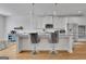 Modern kitchen featuring white cabinets, granite countertops, stainless steel appliances, and an island with seating at 4520 Odum Lake Trl, Cumming, GA 30040
