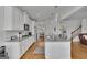 Well-appointed kitchen featuring granite countertops, stainless steel appliances, hardwood floors and white cabinetry at 4520 Odum Lake Trl, Cumming, GA 30040