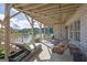 Outdoor patio with lake views, lounge seating, swing, and dining area perfect for outdoor enjoyment at 4520 Odum Lake Trl, Cumming, GA 30040