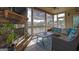Cozy sunroom with stone fireplace, screened windows offering serene views and outdoor access at 4520 Odum Lake Trl, Cumming, GA 30040