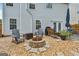 Backyard featuring fire pit, patio, lush lawn, and privacy fence at 142 Holly Mill Village Dr, Canton, GA 30114