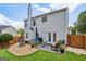 Landscaped backyard featuring patio, fire pit, and well-maintained lawn at 142 Holly Mill Village Dr, Canton, GA 30114