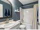 Bathroom features a single sink vanity and shower with tub at 142 Holly Mill Village Dr, Canton, GA 30114
