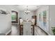 Bright dining room with a modern chandelier and French doors leading to the outside at 142 Holly Mill Village Dr, Canton, GA 30114