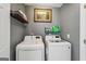 Bright laundry room featuring a side-by-side washer and dryer with storage at 142 Holly Mill Village Dr, Canton, GA 30114