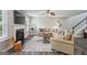 Open-concept living room featuring hardwood floors, a fireplace, and neutral paint creating a warm atmosphere at 142 Holly Mill Village Dr, Canton, GA 30114