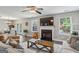 Bright living room boasting hardwood floors, fireplace, ceiling fan, and sliding doors to outdoor space at 142 Holly Mill Village Dr, Canton, GA 30114