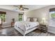 Well-lit main bedroom showcasing a cozy bed and an abundance of natural light at 142 Holly Mill Village Dr, Canton, GA 30114