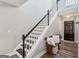 Open stairway features dark handrail, white trim, and hardwood floors leading to an upper level at 142 Holly Mill Village Dr, Canton, GA 30114