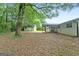Large backyard features a screened-in porch and detached garage, perfect for outdoor living and storage at 1694 Pheasant Dr, Atlanta, GA 30238