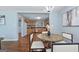 Charming dining area adjacent to the kitchen, featuring a round table, modern chairs, and hardwood floors at 1694 Pheasant Dr, Atlanta, GA 30238