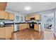 Well-appointed kitchen with stainless steel appliances, wood cabinets, dark countertops, and hardwood flooring at 1694 Pheasant Dr, Atlanta, GA 30238